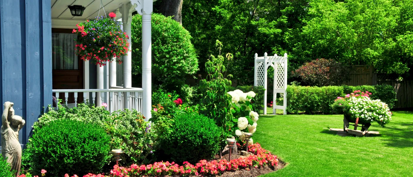 a garden with a house in the background