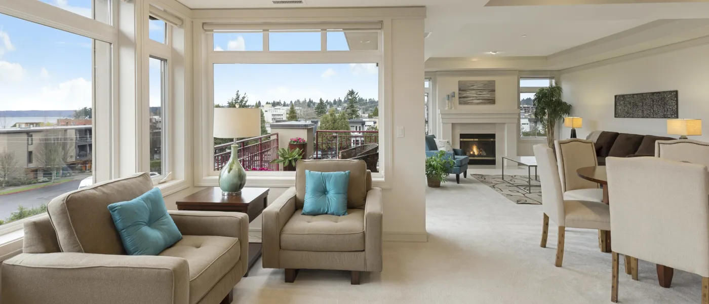 a living room filled with furniture and a large window