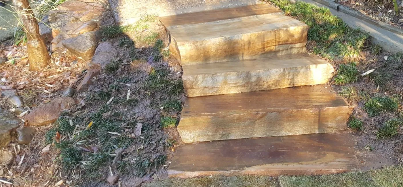 4 Brown stone step treads set in landscape