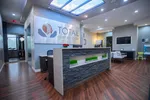 Modern dental office reception area with stone desk