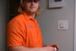 Estes HVAC Professional installing a Thermostat