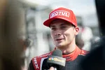 Race car driver in a red Motul cap giving a post-race interview with NBC Sports microphone.