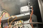 Norcross Atlanta Heating Furnace Repair 30071 by The Air Company of GA.  Open HVAC control panel showing circuit board and multicolored connecting wires inside metal casing.