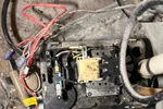 Ac Repair and Maintenance in Smyrna 30080 by The Air Company of GA.   Open furnace or heating unit showing internal wiring, fan, transformer, and connected pipes in dusty basement area.