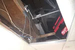 Commercial HVAC Repair in Atlanta 30306 by The Air Company of GA.  Exposed ceiling with ductwork, electrical wiring, wooden beams, and a red Milwaukee tool case in an unfinished space.