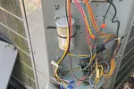 Residential HVAC Repair in Atlanta 30327 by The Air Company of GA.  Open outdoor HVAC unit showing internal wiring, capacitors, and electrical connectors..