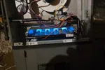 Heating Control Board Repair Atlanta 30324 by The Air Company of GA.  Open furnace showing active blue flames, wiring, and internal components in a basement setting.