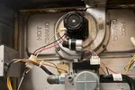 Heating Furnace Repair in Brookhaven Atlanta 30319 by The Air Company of GA.  Open residential furnace showing internal blower, burner assembly, wiring, and hot gas pipes.