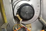 Residential Heating Furnace Repair in Norcross Atlanta 30071 by The Air Company of GA.  Inside view of a furnace showing blower motor, wiring, and gas valve components in metal casing