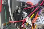 Commercial HVAC Repair in Atlanta Decatur 30317 by The Air Company of GA.  Close-up of electrical wiring and components inside a device with multiple colored wires and labels.