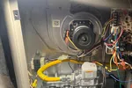 Atlanta HVAC Heat Furnace Repair 30338 Dunwoody by The Air Company of GA.  Open furnace showing internal wiring, circuit board, blower motor, and gas valve inside metal housing.