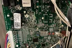 AC Repair in Roswell GA by The Air Company of GA. Close-up of a complex electronic circuit board with multicolored wires connected inside a device.