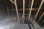 Commercial HVAC Repair in Atlanta 30306 by The Air Company of GA.  Attic space with exposed wooden beams, HVAC ducts, insulation, and mechanical equipment under the roof structure.
