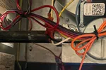 Residential HVAC AC Heating Repair Atlanta Brookhaven 30319 by The Air Company of GA.  Interior view of a furnace showing blue gas flames, wiring, and control components inside the metal casing.