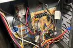 Residential Heating Furnace Repair in Norcross Atlanta 30071 by The Air Company of GA.  Inside view of an open furnace showing a circuit board and colorful electrical wiring connections.