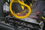 Commercial HVAC Repair in Dunwoody 30338 by The Air Company of GA.  Interior of a Goodman furnace showing yellow gas line, wiring, and burner assembly.