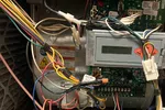 Heating Furnace Repair in Brookhaven Atlanta 30319 by The Air Company of GA.  Open electrical panel showing circuit boards, wiring, and connectors inside a HVAC unit enclosure.
