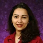 Smiling woman with dark hair wearing a red blouse against a purple textured background.