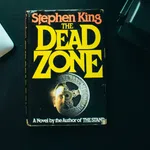 Stephen King’s novel The Dead Zone with overlaid title text in yellow on a black book cover.
