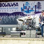 Live blues band performing on stage at the Bogalusa Blues and Heritage Festival outdoor event.