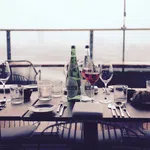 a table with wine glasses and bottles