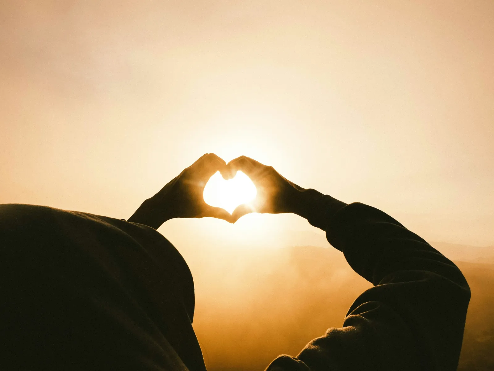 a pair of hands holding a light