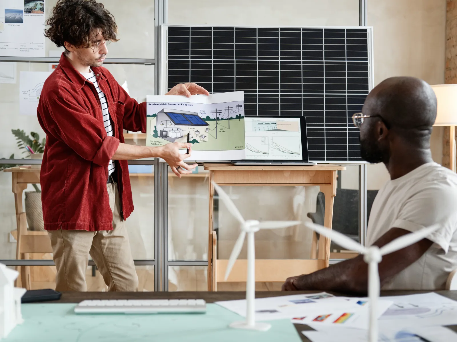 a person showing a person something on a paper