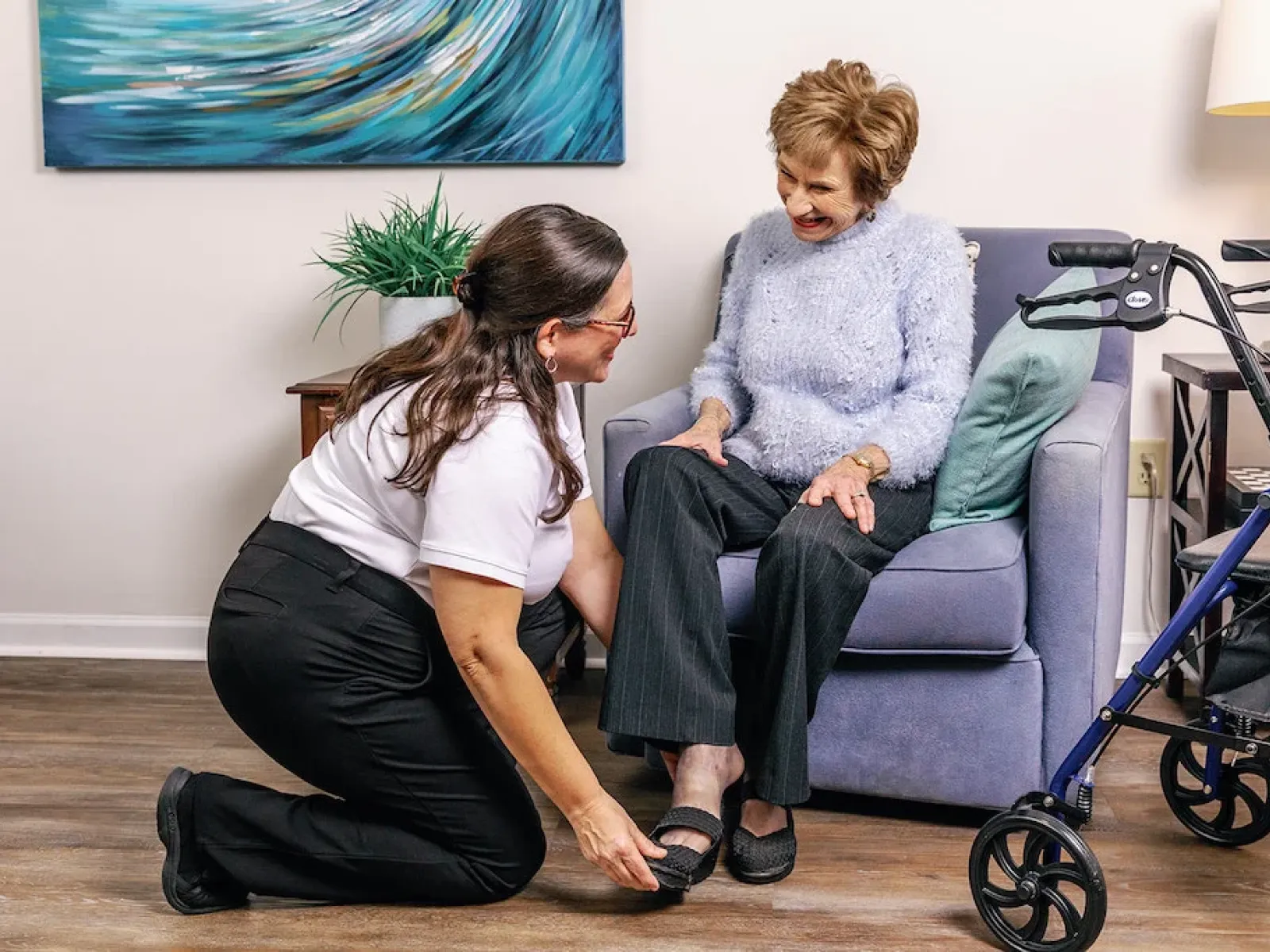 a person sitting next to a person in a wheelchair