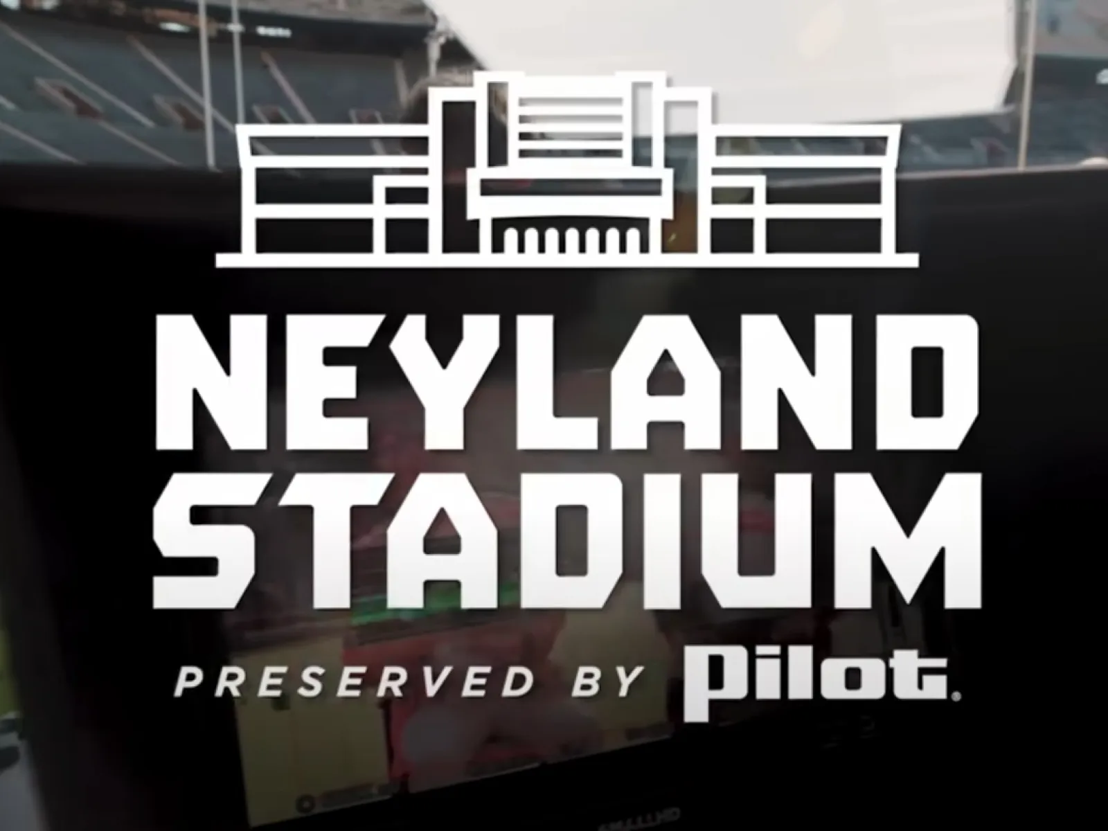Neyland Stadium logo overlay at an empty football stadium, preserved by Pilot sponsorship.