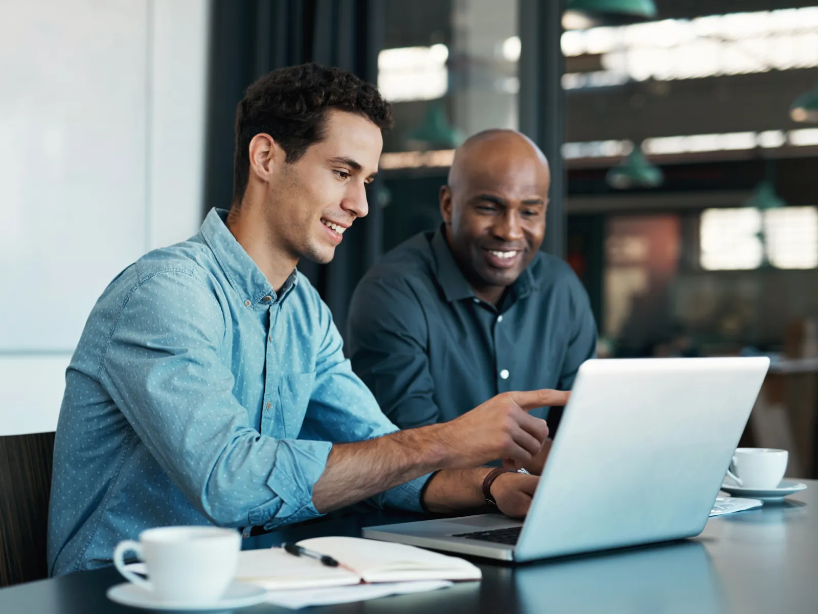 a few men looking at a laptop