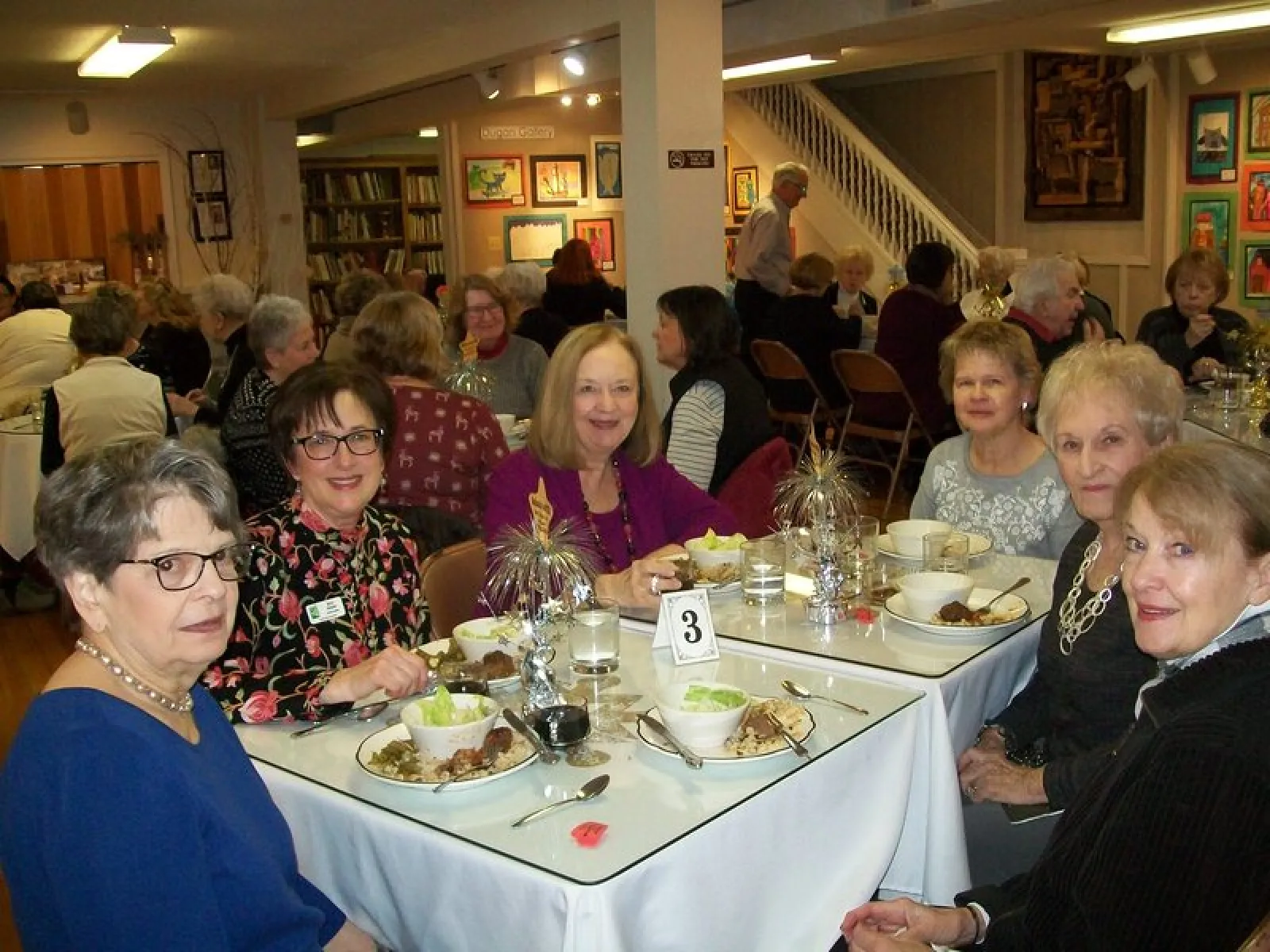 a group of people sitting at a table eating food