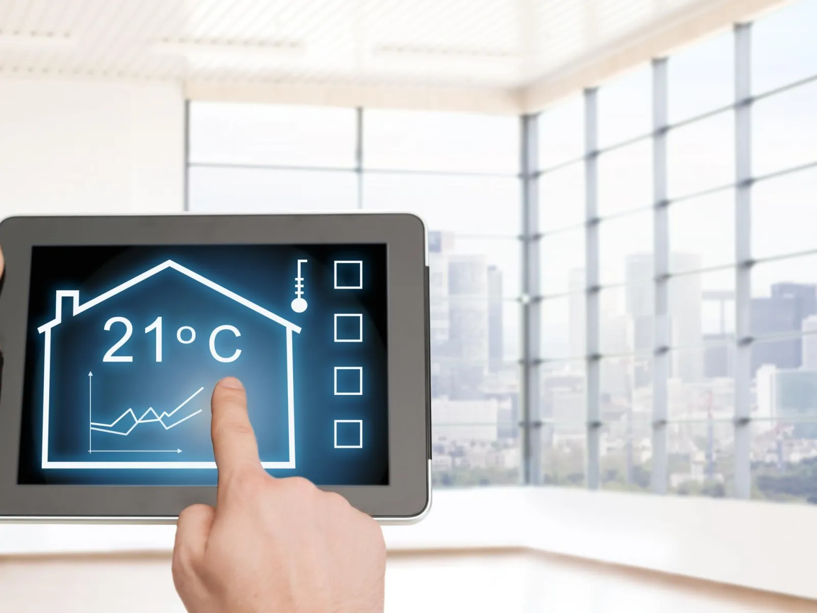 Person using tablet to control smart home temperature set at 21 degrees Celsius in bright modern room.