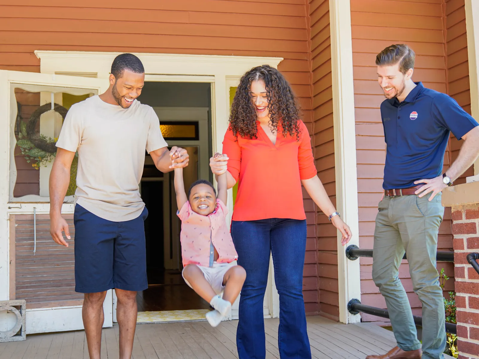 a group of people standing outside a house