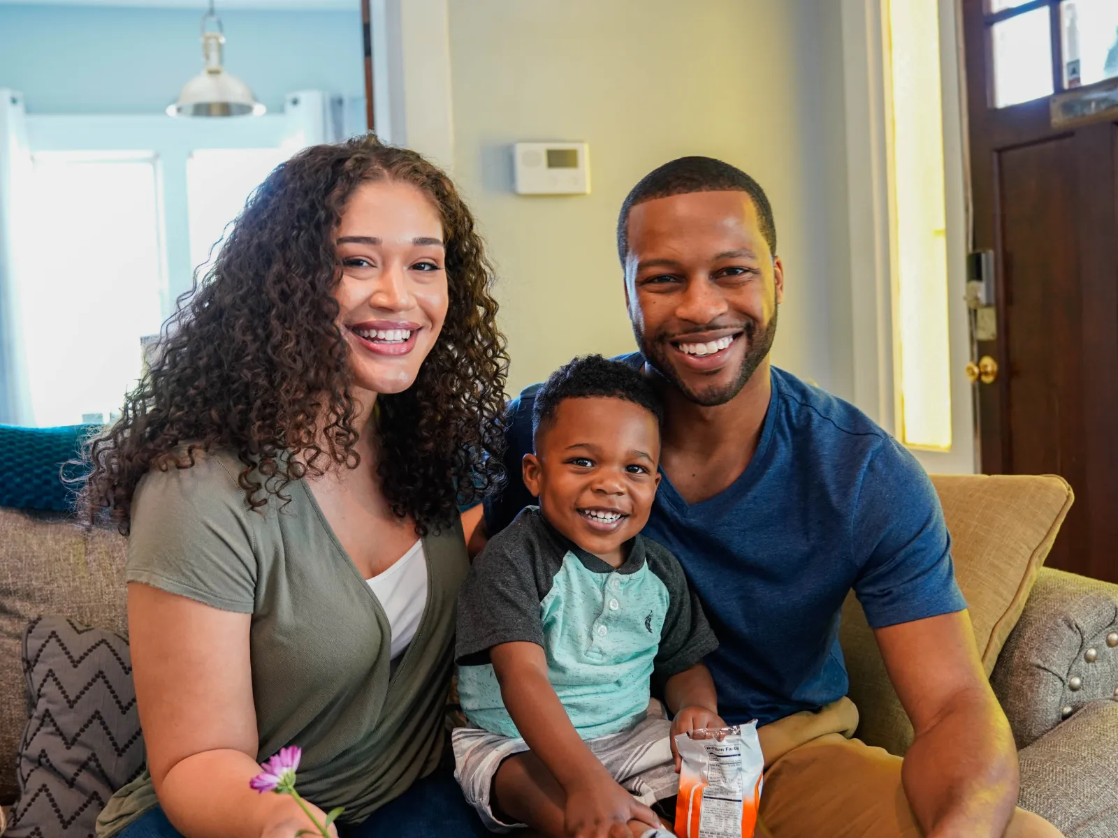 a family sitting on a couch