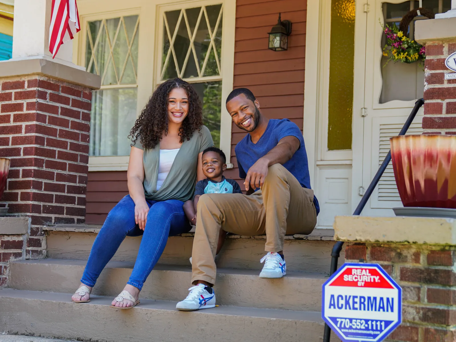 people sitting on a porch with a child