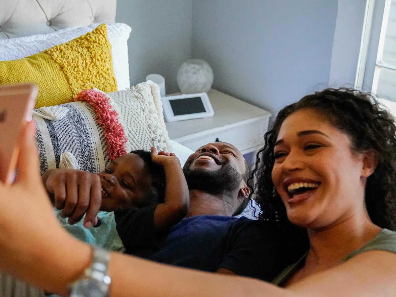 a woman taking a selfie with a man and a child