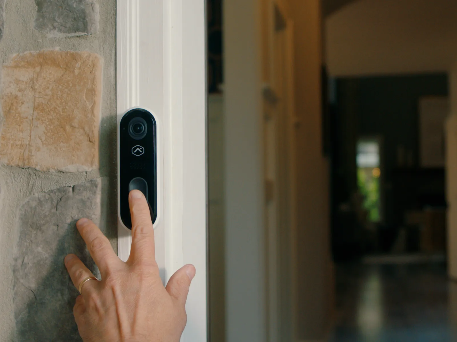 a finger pressing a doorbell