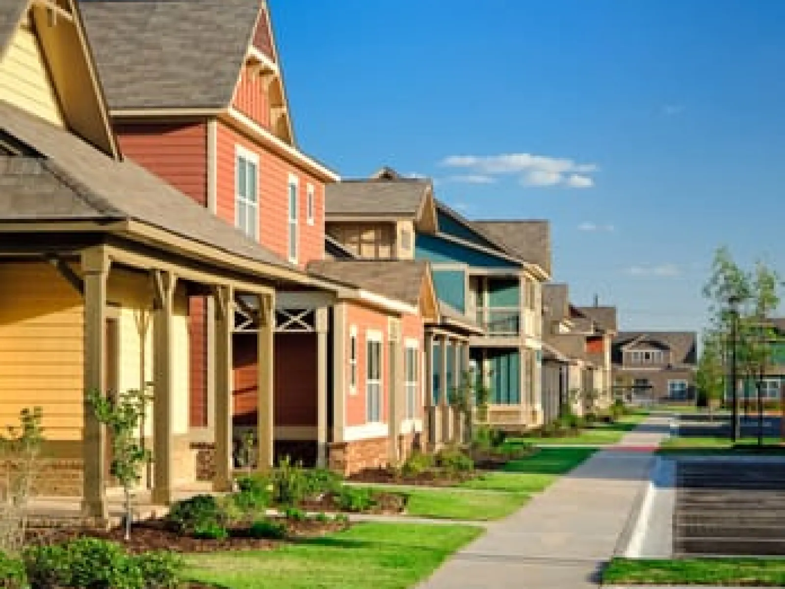 Row of colorful suburban houses with porches and manicured lawns in Athens GA