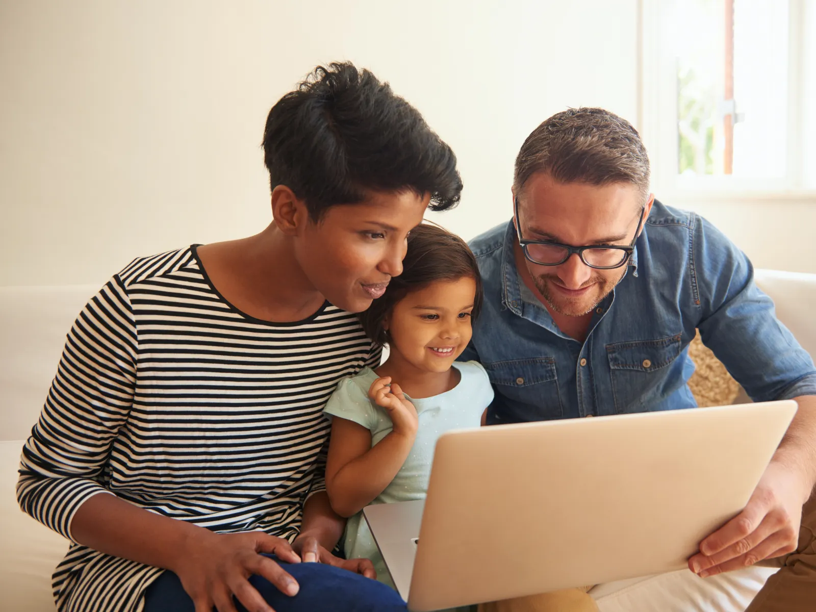 a family looking at a laptop