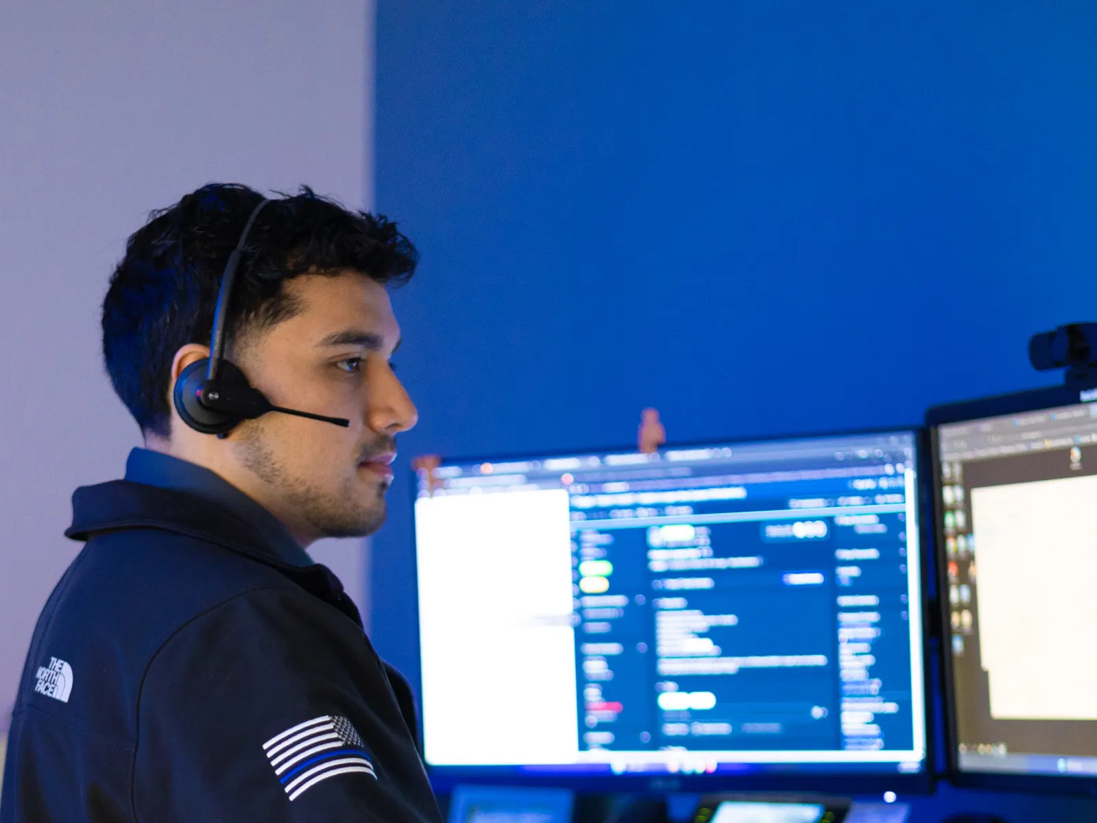 a man wearing headphones and using a computer