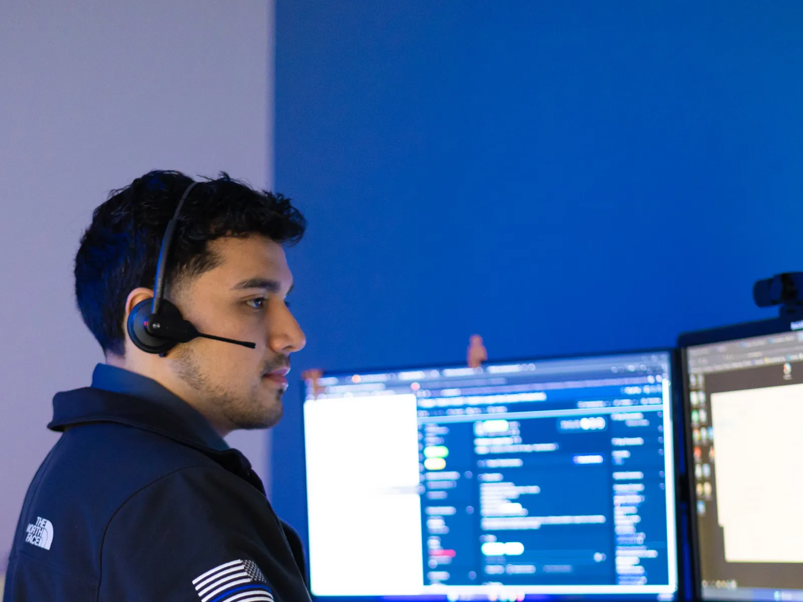 a man wearing headphones and using a computer