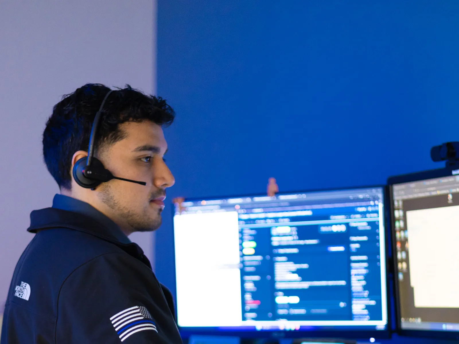 a man wearing headphones and using a computer