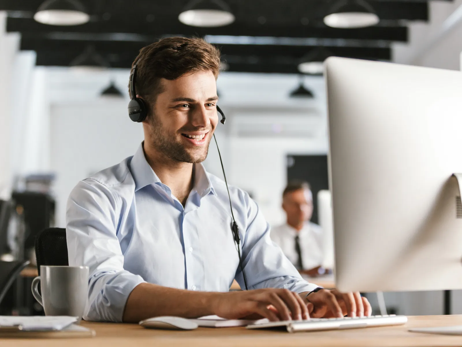 a man wearing headphones and sitting at a desk