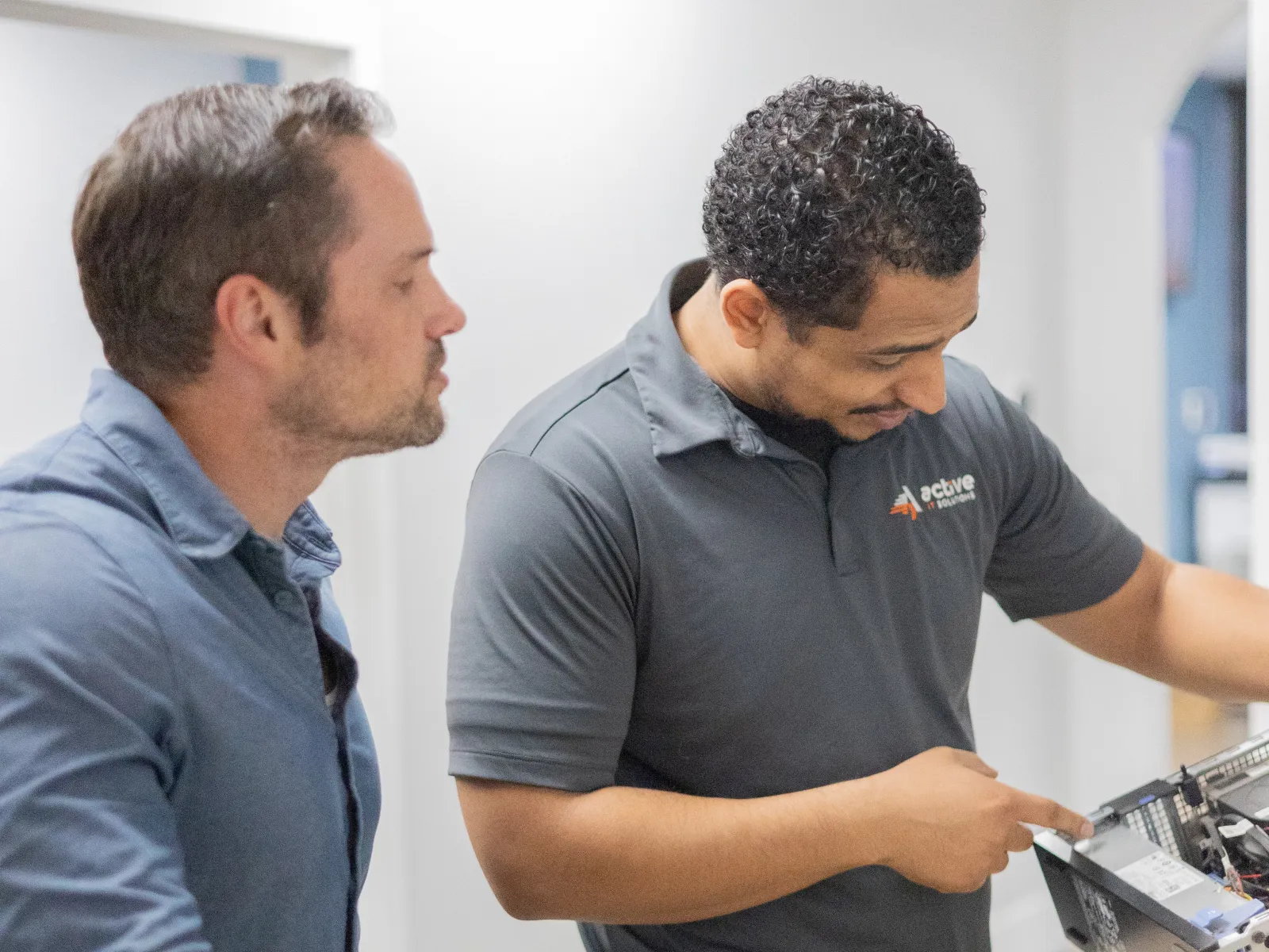 a couple of men looking at a computer screen