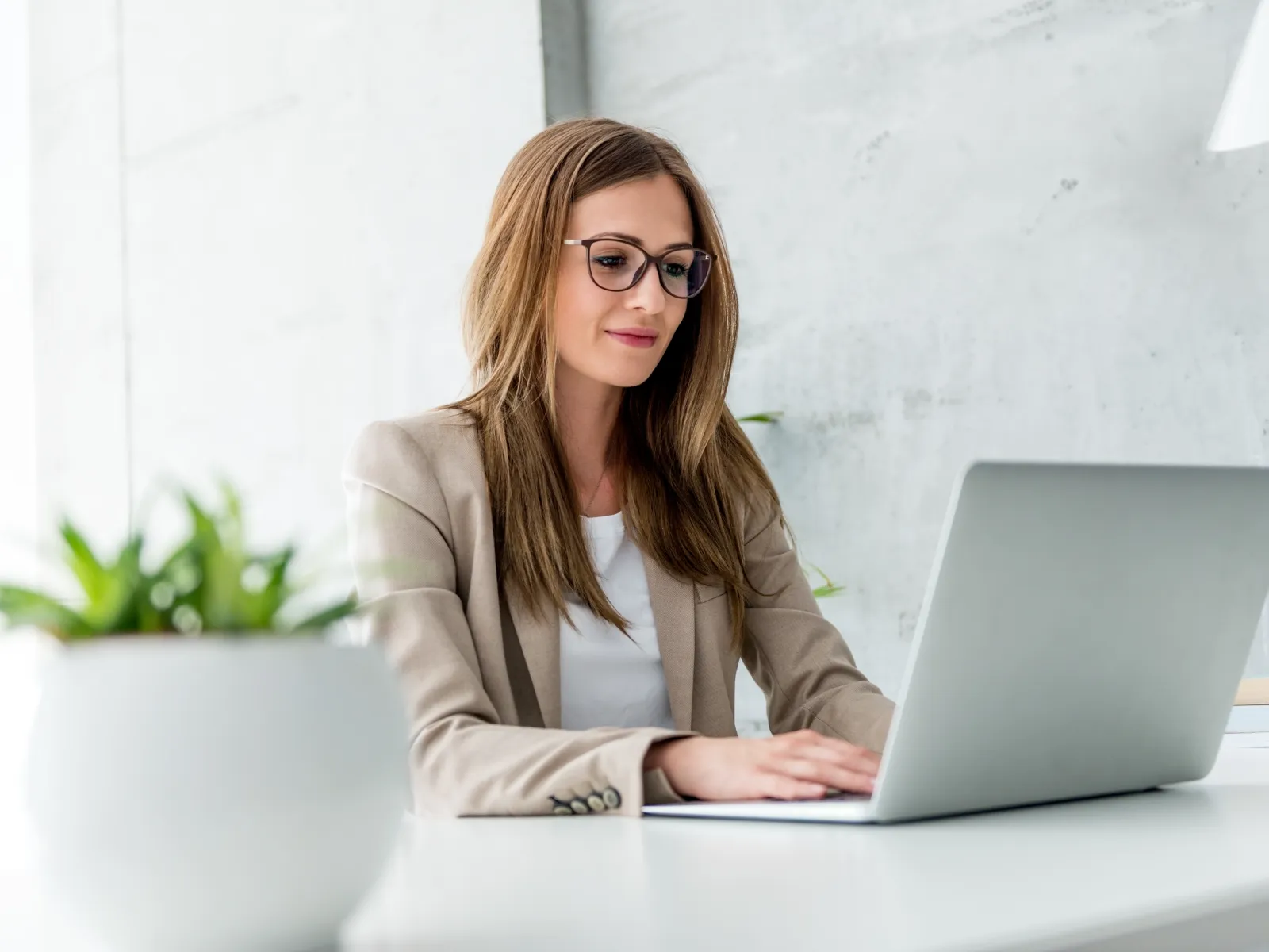 a woman sitting at a table with a laptop