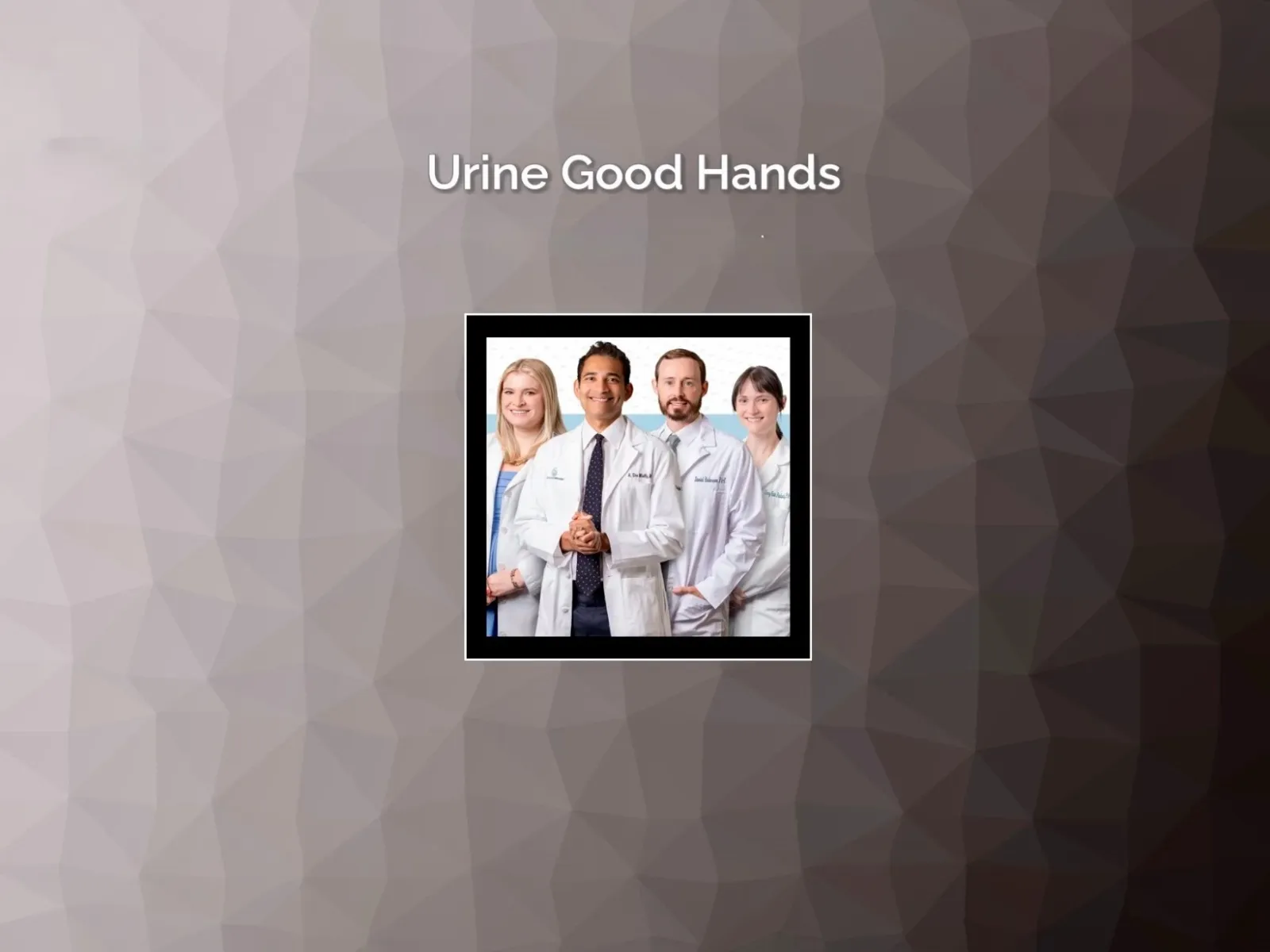 Four doctors in white coats standing together and smiling against a white background