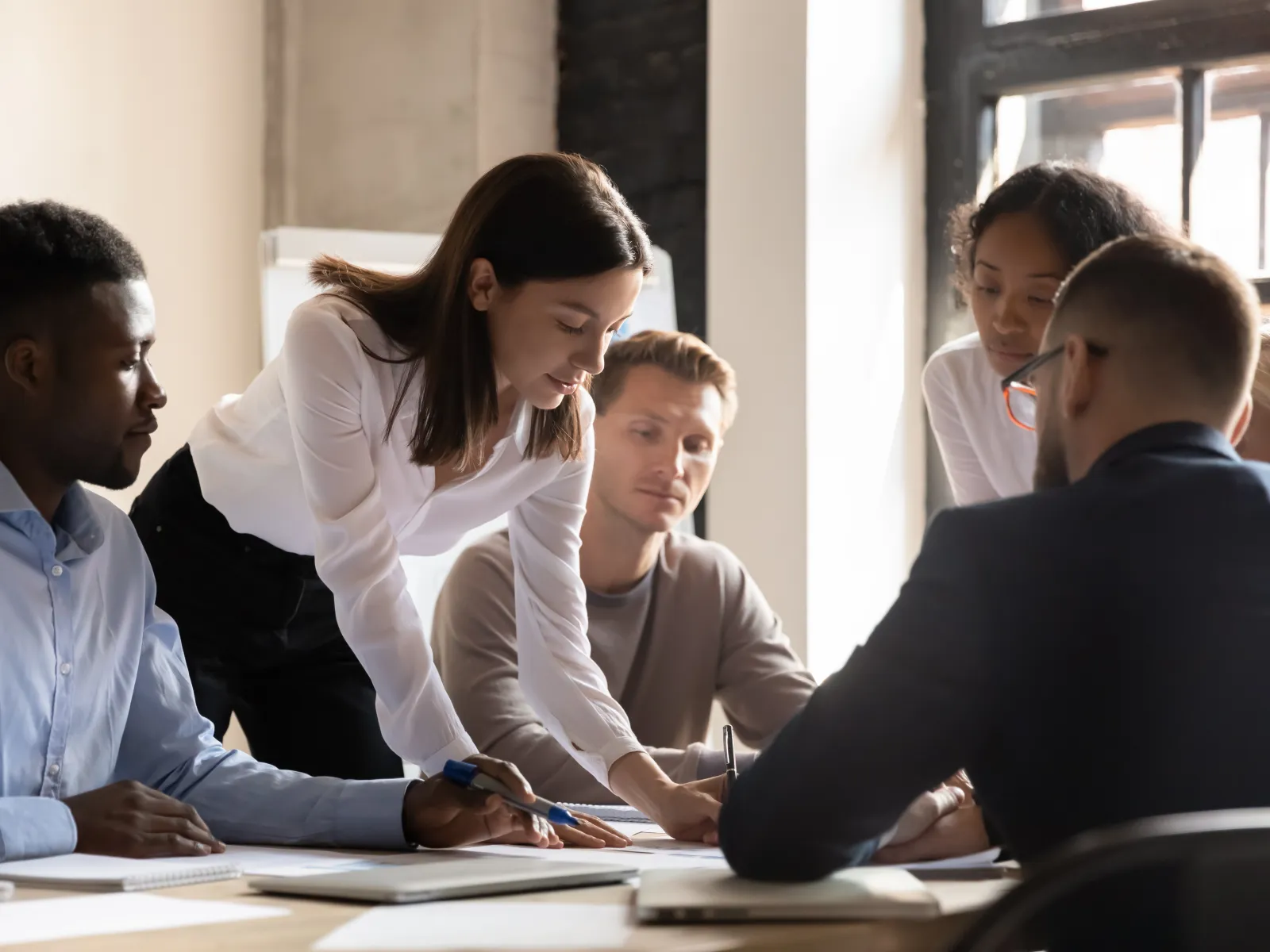 a group of people looking at a paper