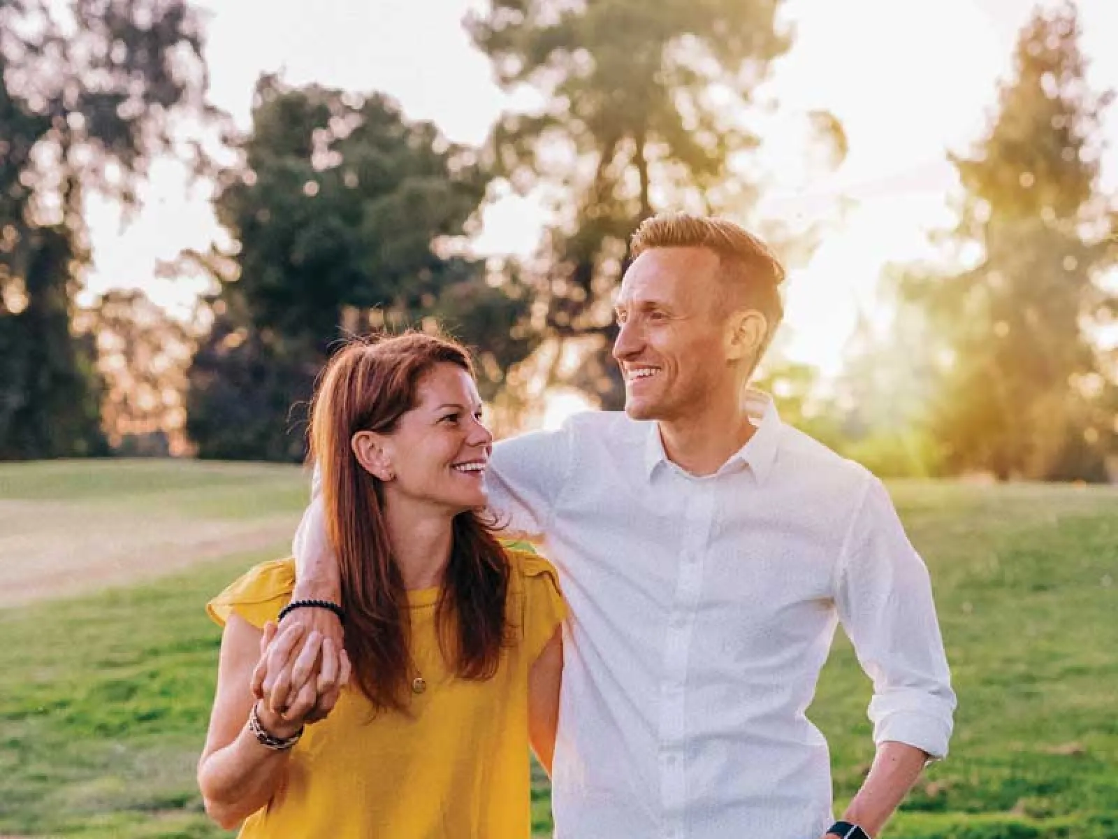 couple standing in a grassy field
