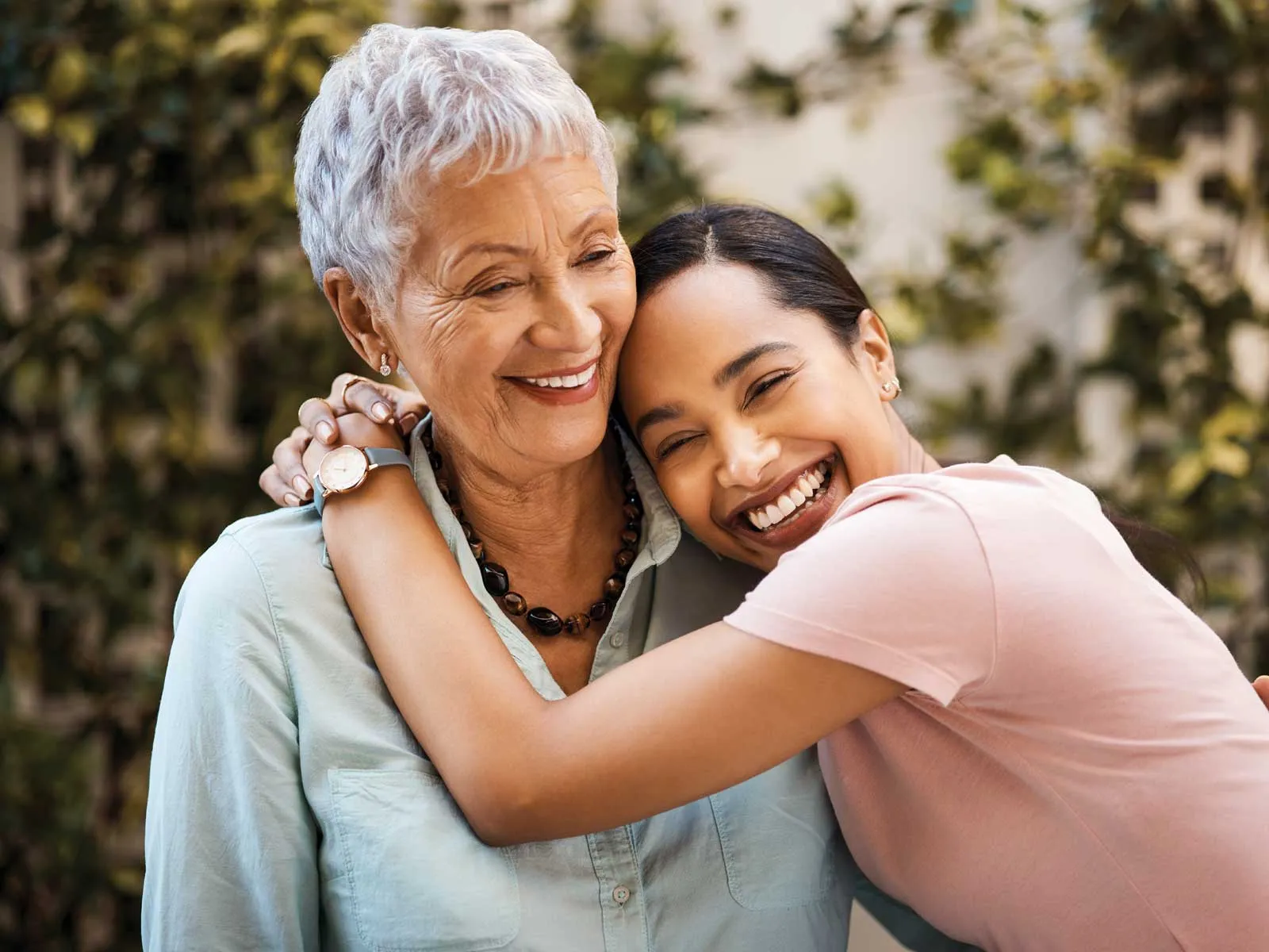 Modern dental exam room with chair, overhead light, dual monitors, and large window with blinds