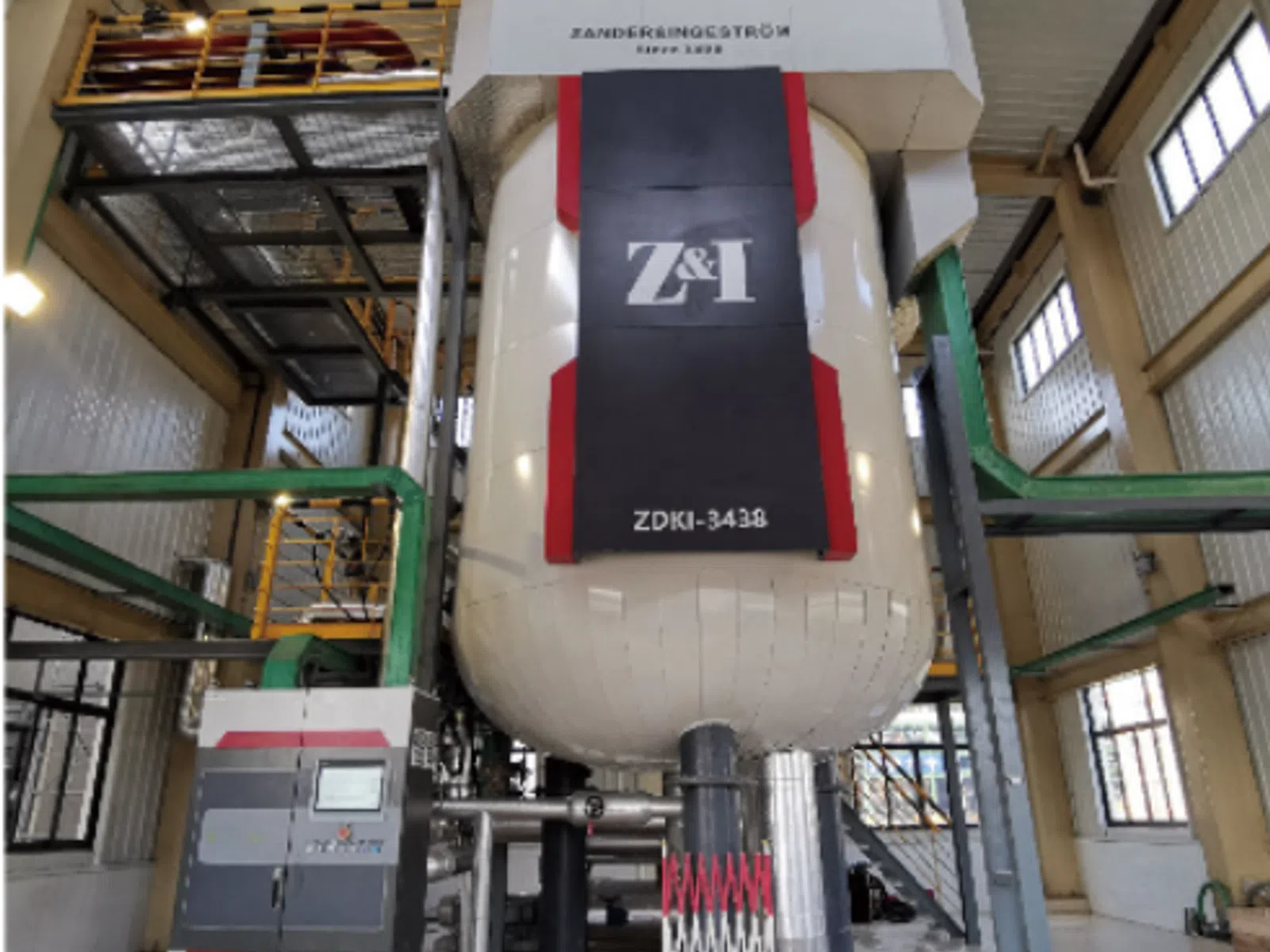 Industrial Sandgringstrom Z&1 ZDKI-3438 equipment inside a large factory with control panel and metal structures.